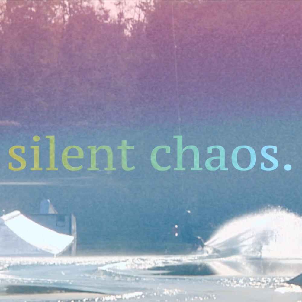 Wakeboarder carving through spray at a cable park with soft pastel overlay and “silent chaos.” text.