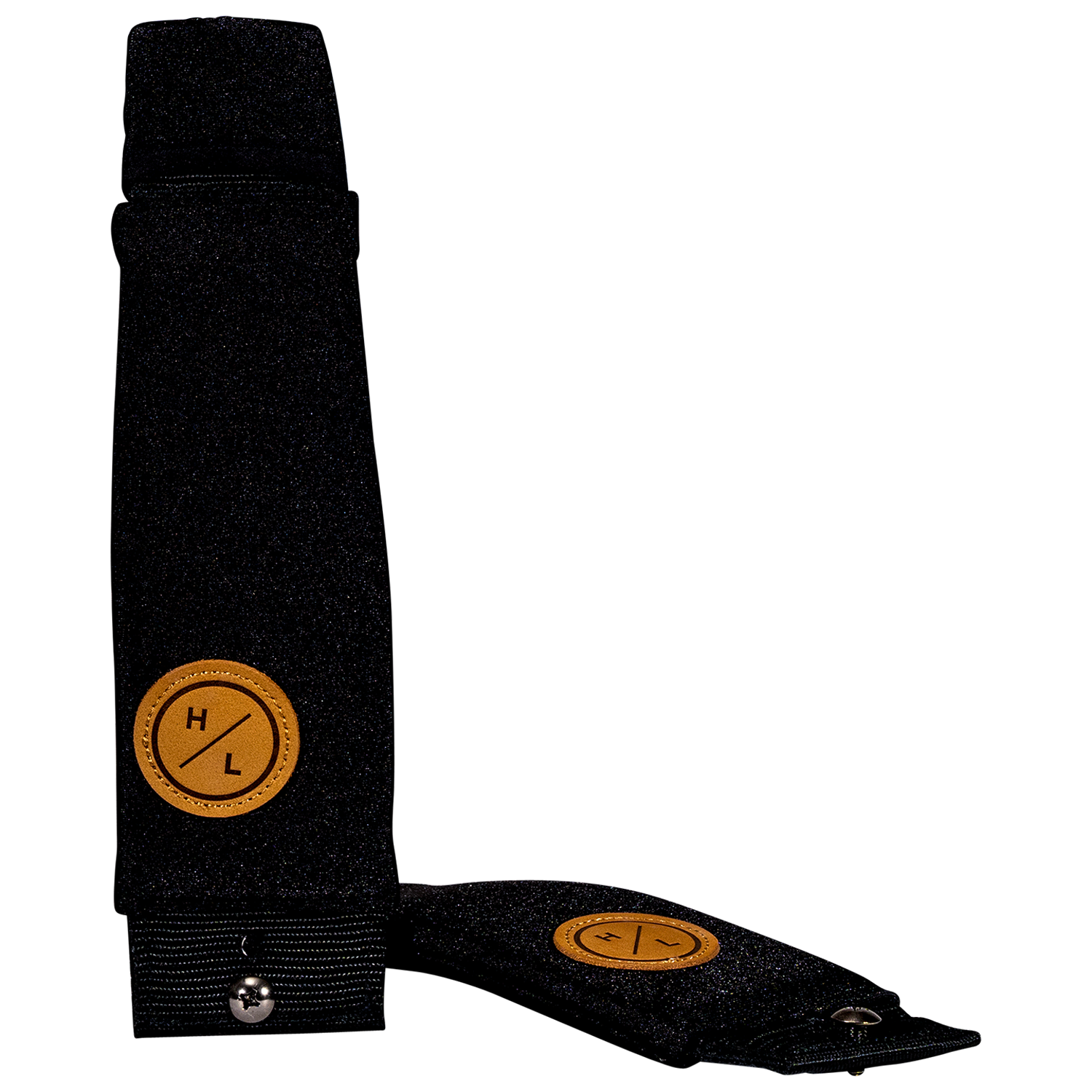Vertical view of one black foil board foot strap standing upright beside another lying flat.