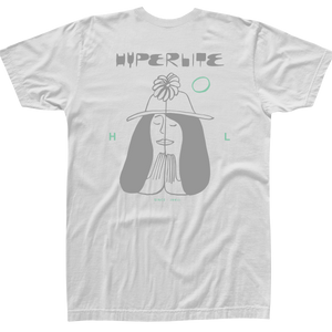 Back view of a white short-sleeve t-shirt with a large graphic of a peaceful woman wearing a hat and praying hands, ‘Hyperlite’ text above, and small mint green accents and text reading ‘Since 1991.