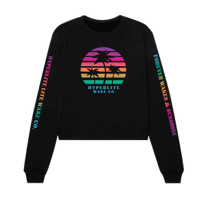 Front view of a black crew neck sweater with very bright rainbow colored Circle logo with black palm trees and the words Hyperlite Wake below that image. On the sleeves, the words Hyperlite Wake CO on the right arm and Forever Wakes & Sunshine on the left arm.