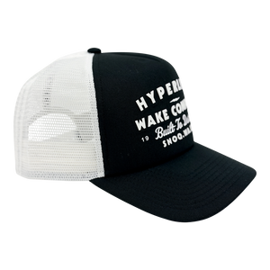 Angled side view of the Harley Trucker Hat showing black front panel and white mesh back.