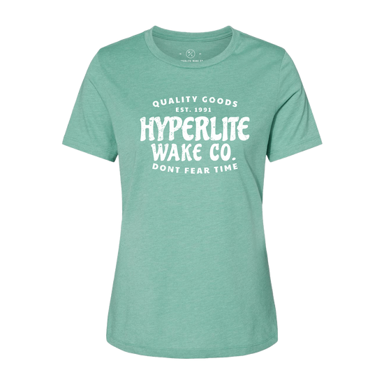 Front view of green womens t-shirt with a large white logo that states Quality Goods, EST 1991, Hyperlite Wake CO., Don't fear time on the center of the chest.