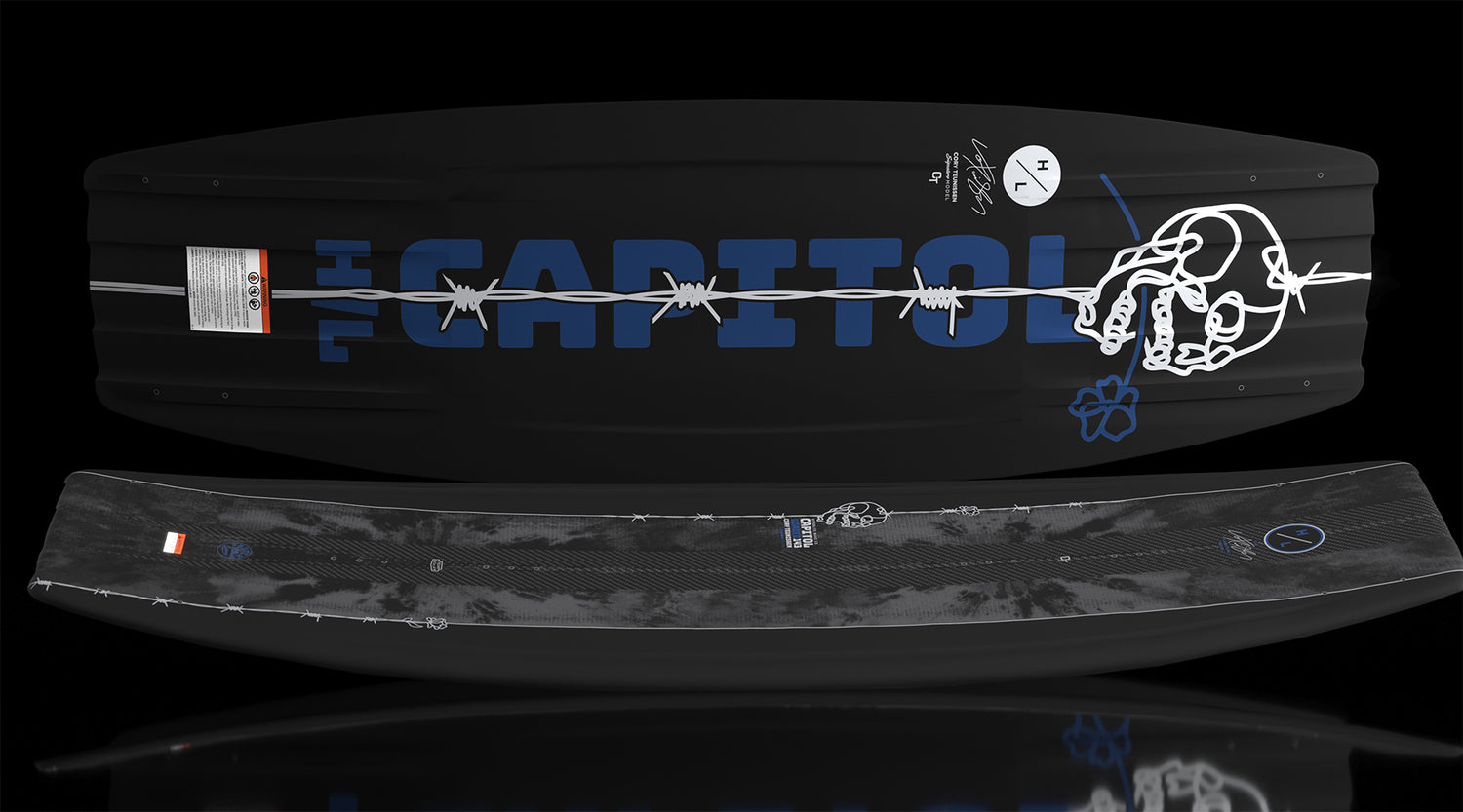 Capitol Loaded wakeboard laid flat showing barbed wire graphic across black base.