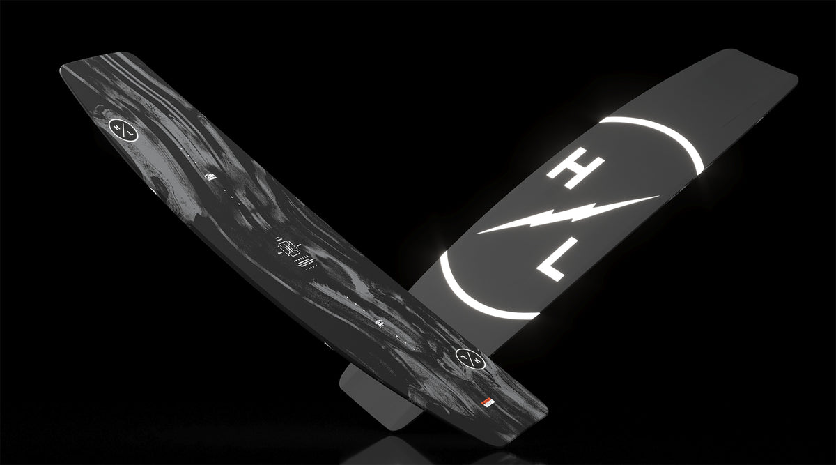 Angled side view of Impulse board with swirling black marbled top and HL lightning logo.