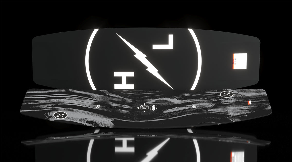 Angled view of Impulse wakeboard showing marbled top and bold HL lightning logo on base.