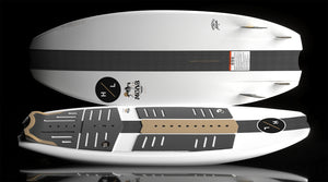 Close-up of MOAB board deck with black and brown traction pads and carbon fiber stripe.