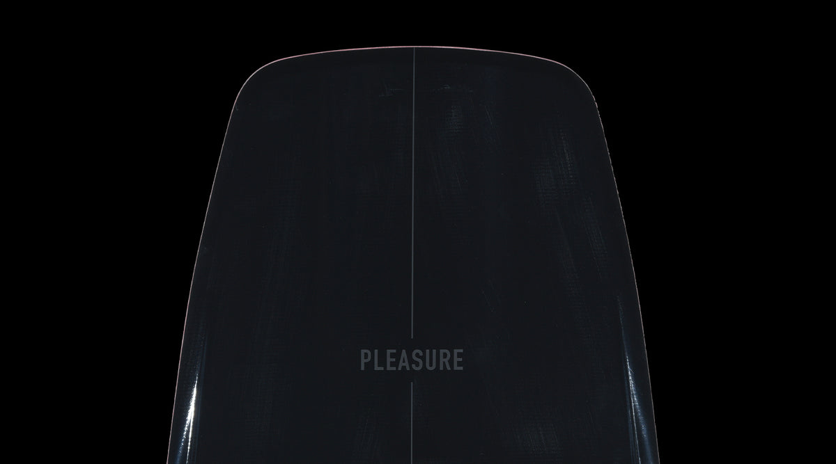 Close-up of the Pleasure wakeboard nose showing subtle centerline and glossy black finish.