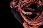 Close-up of 25 Pro Surf Rope w/ Handle in black and orange with foam endcaps.