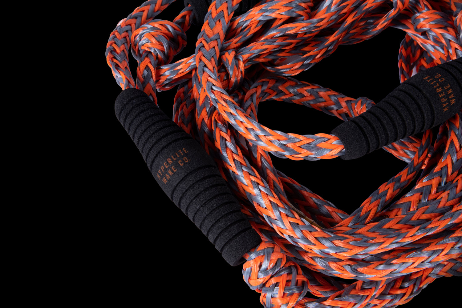 Close-up of 25 Pro Surf Rope w/ Handle in black and orange with foam endcaps.