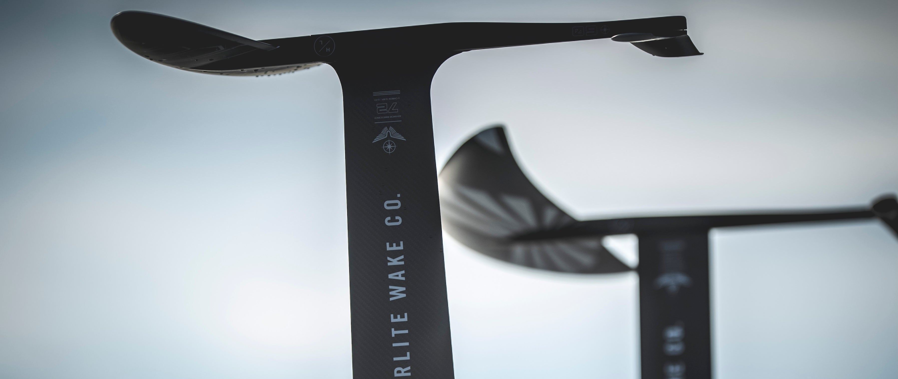 Close-up of two hydrofoil masts with the words RELITE WAKE CO. visible.