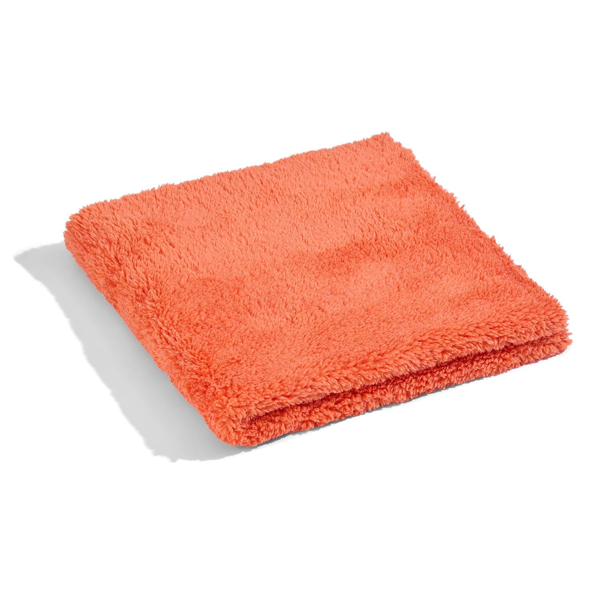 Orange microfiber cleaning towel neatly folded.