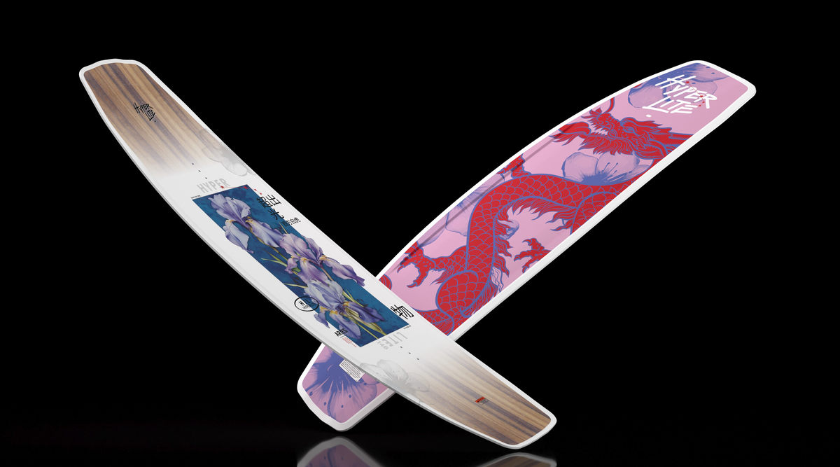 Angled view of two crossed Aries wakeboards with a white iris top and pink dragon base.