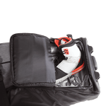 Sneaker in a partially open Wheelie Board Bag compartment against sleek black.