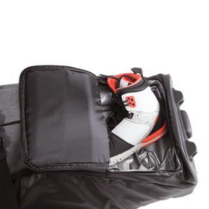 Sneaker in a partially open Wheelie Board Bag compartment against sleek black.