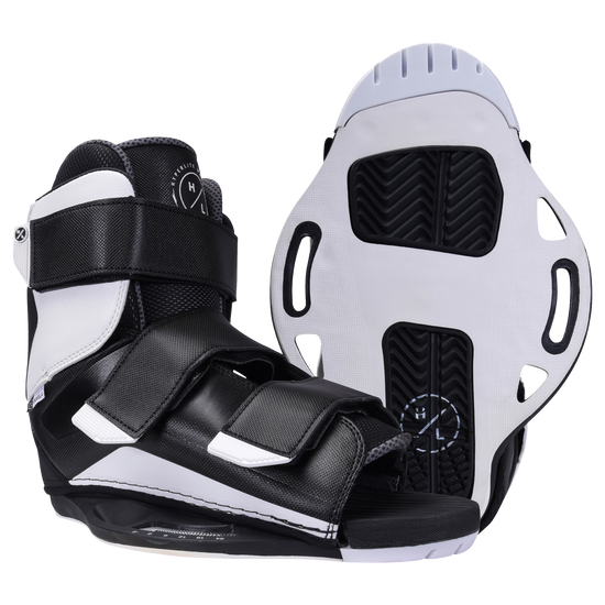 Sender boots with textured soles and adjustable straps, in black and white.