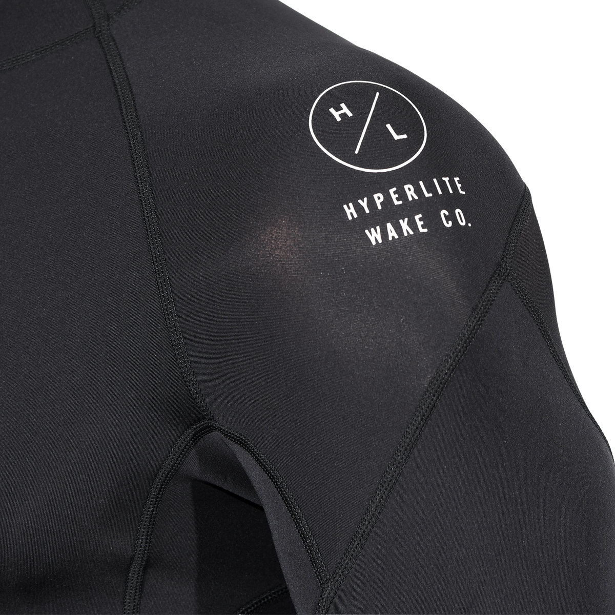 Close-up of the shoulder on Wetsuit Top showing a white Hyperlite Wake Co. logo and stitched neoprene seams.